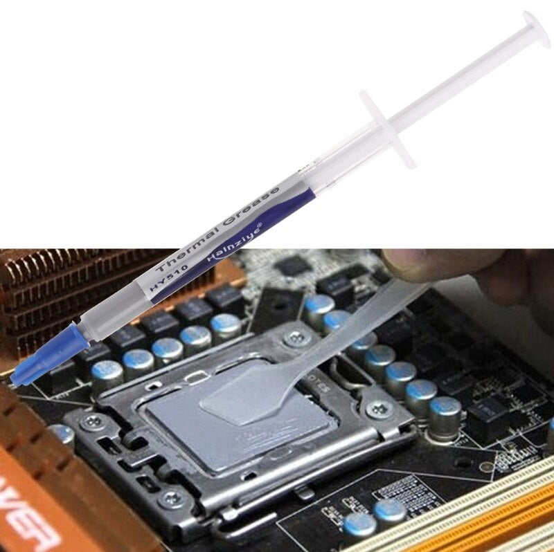 A syringe-style application tool labeled 'TECHMETIC OIL GREESE' is shown above a close-up of a hand applying the substance to a CPU socket on a motherboard.