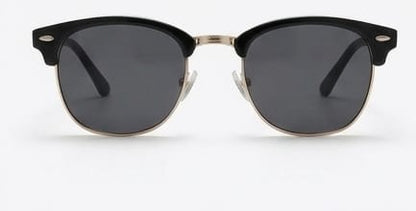 Sunglasses with black lenses and gold frames on a white background