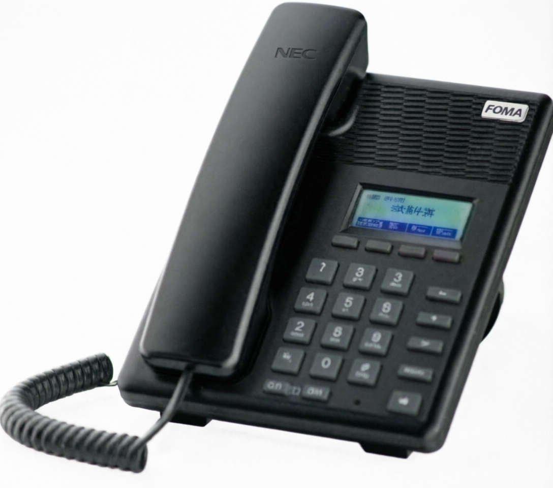 A black NEC FOMA landline telephone with a coiled cord, numeric keypad, and small display screen, shown on a plain white background.
