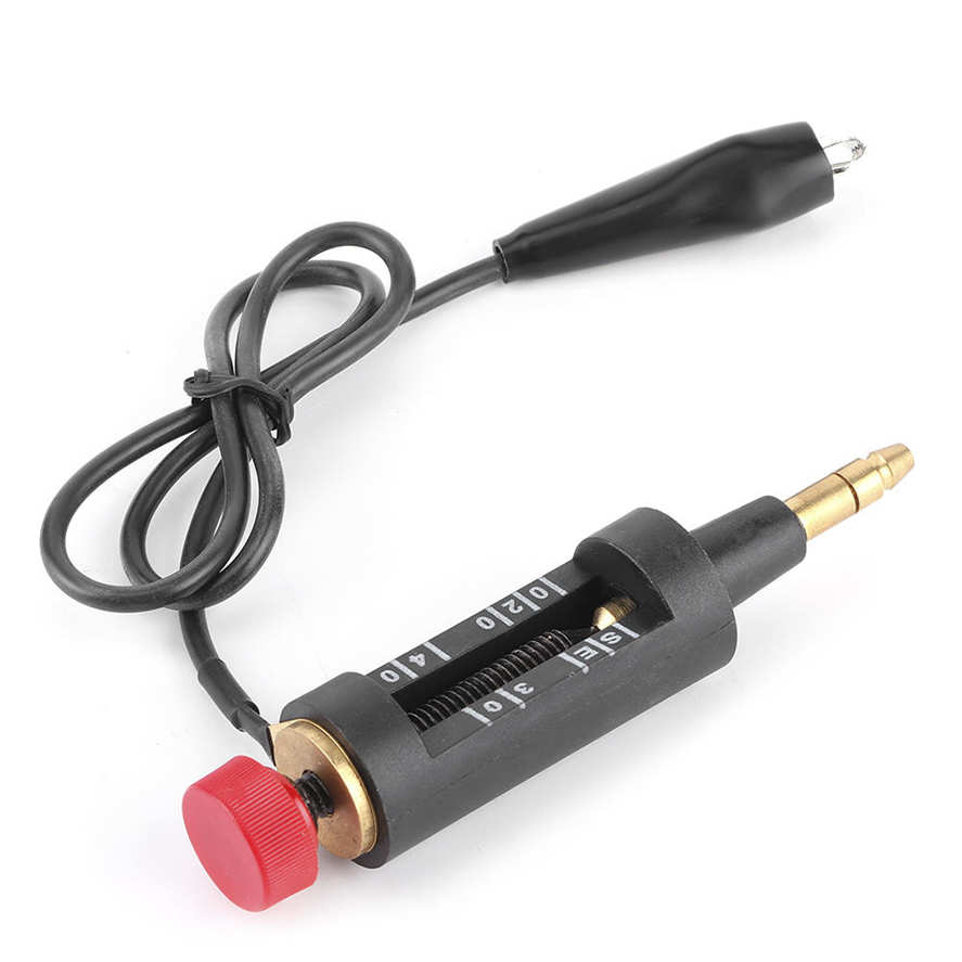 A black audio impedance adapter with a red adjustment knob, brass-plated contacts, and a black cable, shown on a white background.