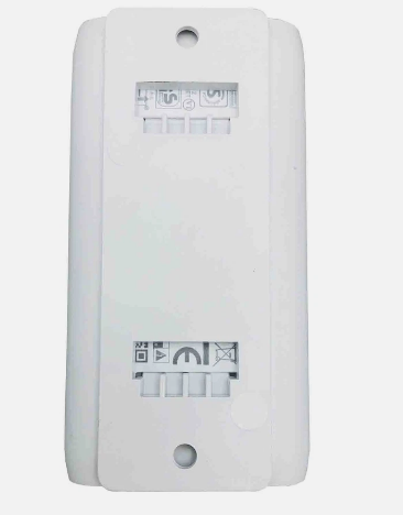 A white plastic electrical terminal block or connector plate with screw terminals and printed connection symbols, shown against a light gray background.