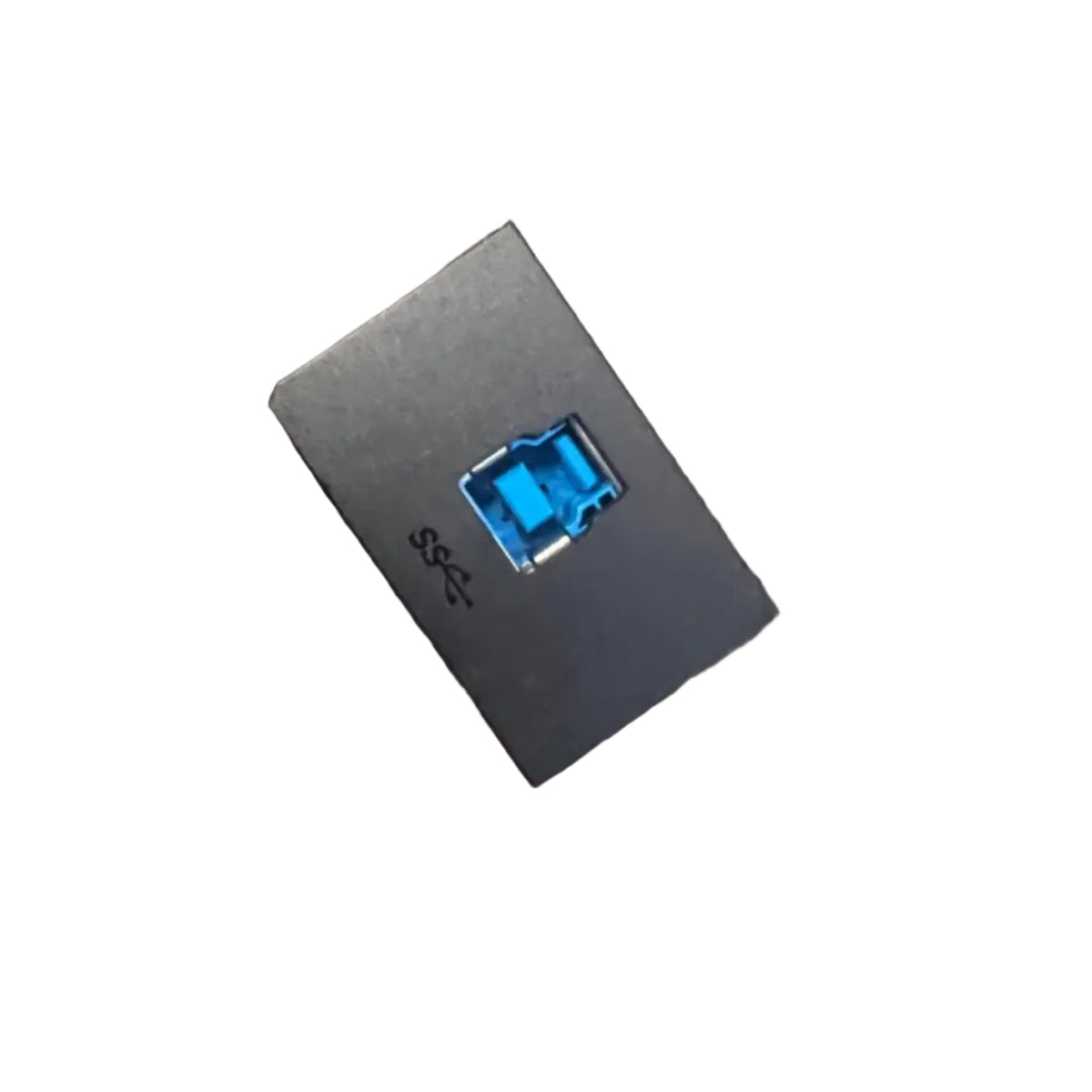A hand holding a small black rectangular electronic component with a blue USB-A port, with a black cable in a clear plastic bag below it, set against a gray carpeted background.