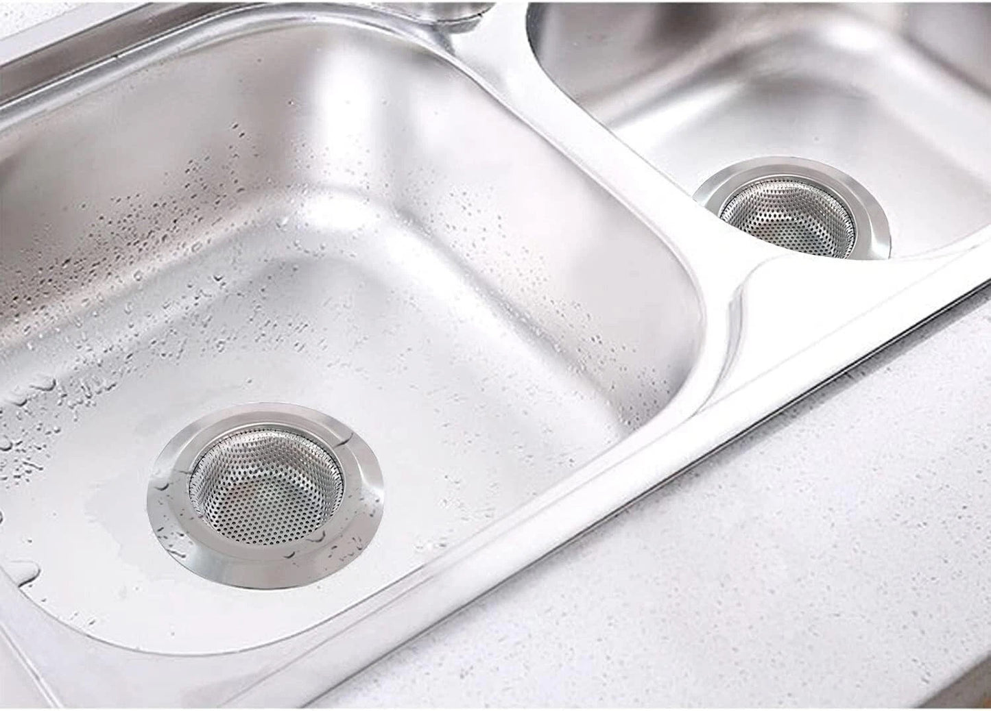 Stainless steel kitchen sink with visible water spots and grime