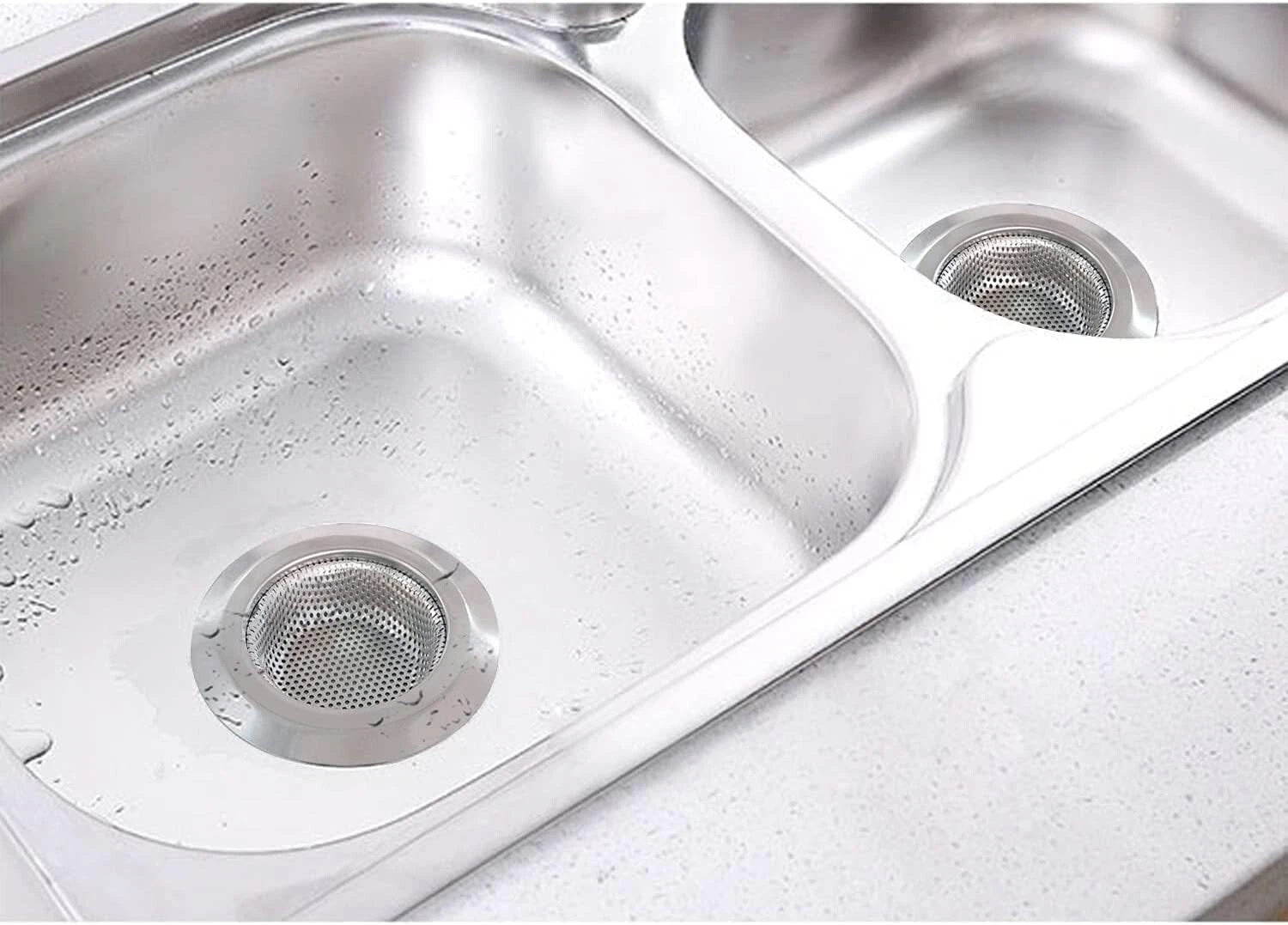 Stainless steel kitchen sink with visible water spots and grime