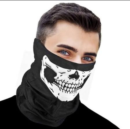 Person wearing a black face mask with a white skull design, bike riding mask Pakistan, on a white background.