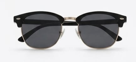 Black sunglasses with gold frames on a white background